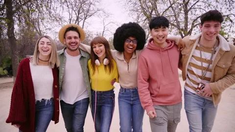 Large group diverse smiling young people strolling together in park. Casual Stock Footage 253035609