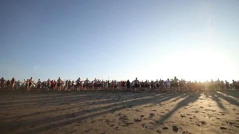 A Large Group does Jumping Jacks on the Beach Stock Footage 88964668