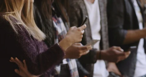 Large group of friends using cellphone. shot in slow motion Stock Footage 89613367