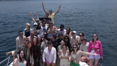 A large group of friends waves to the camera on a yacht Stock Footage 275344862