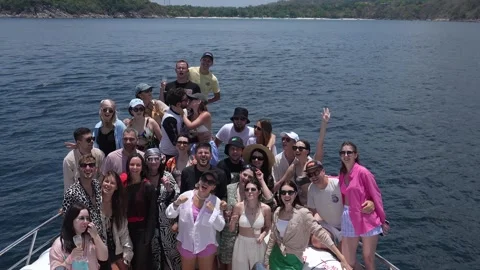 A large group of friends waves to the camera on a yacht Stock Footage 275344869