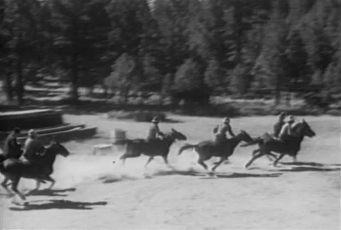 Large group of men on horseback galloping through the countryside, 1930s 스톡 동영상 95997532