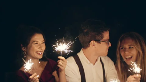 Large group of multiracial friends or acquaintances holding and waving sparklers Stock Footage 172080731