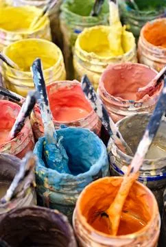 Large group of open cans of multi-colored paints Stock Photos