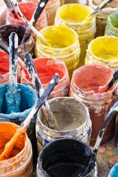 Large group of open cans of multi-colored paints Stock Photos