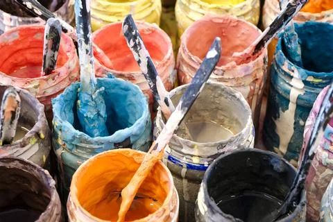 Large group of open cans of multi-colored paints Stock Photos