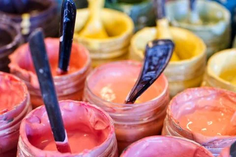 Large group of open cans of multi-coloured paints Stock Photos