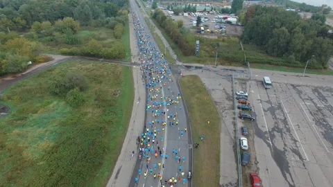 A large group of people running a marathon outdoors in urban setting Stock Footage 130774350