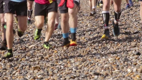 Large group of people running on the pebble beach Stock Footage 125963425