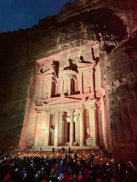 Large group of people sitting on the ground at night, the rock cut architec.. Stock Photos