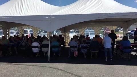 Large Group of People Under Tent Stock Footage 77143384