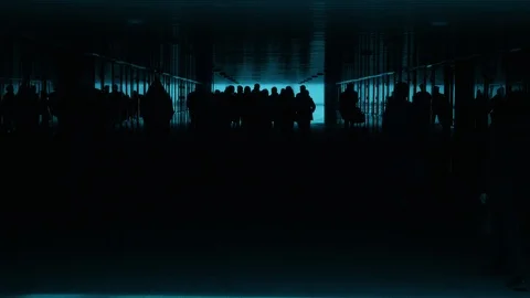 A large group of people is walking through a black and blue underground passage. Stock Footage 111256705
