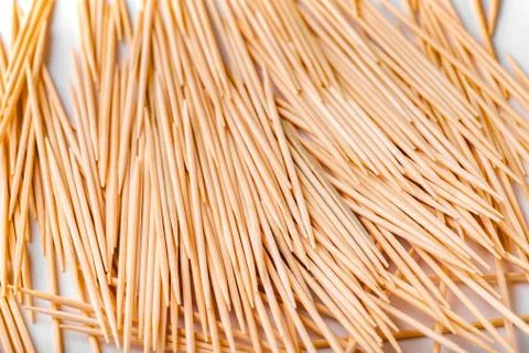 A large group of pointed, sharp toothpicks made of wood close-up. Texture, pa Stock Photos