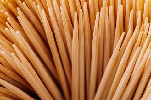 A large group of pointed, sharp toothpicks made of wood close-up. Texture, pa Stock Photos
