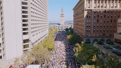Large Group of Protestors Marching Though Downtown San Francisco Stock Footage 319772702
