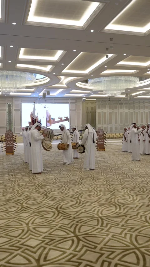 A large group of Qatari men perform the traditional Ardah sword dance in a Stock Footage 341840243