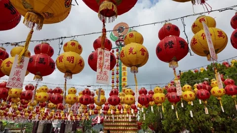 A large group of red and yellow lanterns hanging from a pole Stock Footage 317307570