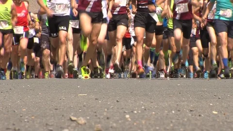 Large group of runners competing in race (legs only) Stock Footage 113399601