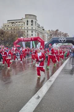 Large group of runners dressed as Santa Claus during Christmas charity run Stock Photos