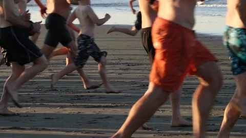 Large group runs toward the Ocean Video stock 88964881