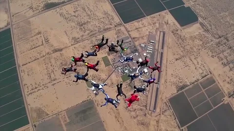 A large group of skydivers form free-fall formations. Stock Footage 244815715