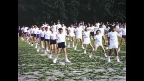 Large group of students performing synchronized calisthenics outdoors in th.. Stock Footage 336166802