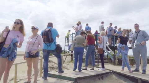 A large group of tourists photograph landscapes of the Curonian Spit National Stock Footage