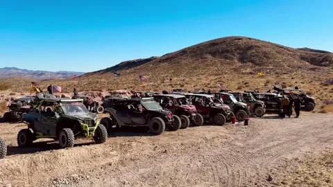 A large group of UTVs aka Side-by-sides parked in the desert near Beatty, Nevada Stock Footage 299940704