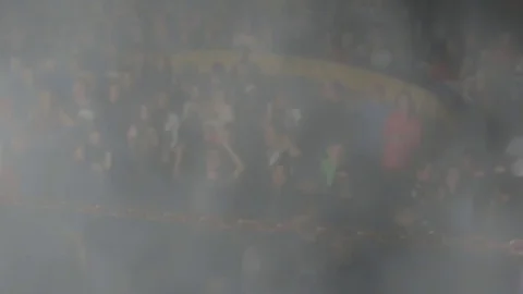 A large group of young people are dancing in the smoke Stock Footage 100854558