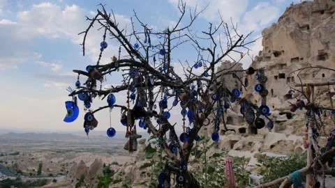 Large groups of blue bead worn against the evil eye hanging on trees Stock Footage 160603387