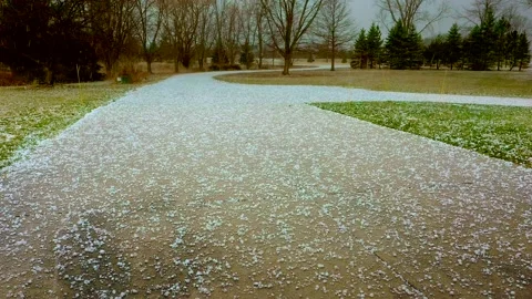 Large hail falling, pummeling driveway in springtime Stock Footage 181500032