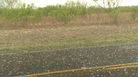 Large hail falling on road, golf ball sized hailstones Stock Footage 504103