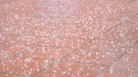 Large hail falling on the road, heavy rain, summer thunderstorm with hail.  Stock Footage 248088180