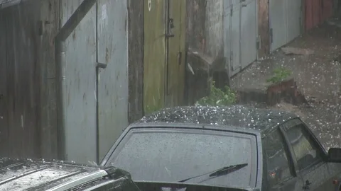 Large hail stones pelting car roof during storm Stock Footage