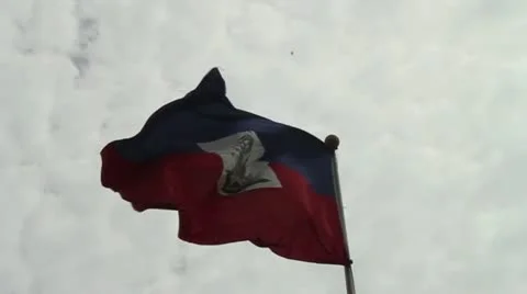 Large Haitian flag blows in the wind on Champs de Mars in Port-au-Prince Stock Footage 16790413