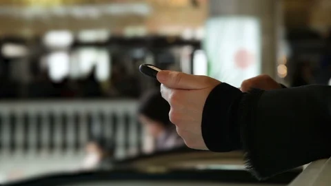 Large Hands with a phone type a message in a shopping center Stock Footage 114212589
