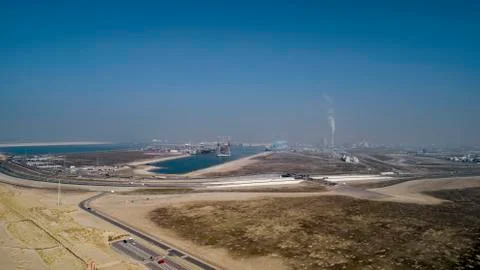 Large harbor cranes loading container ships in the port of Rotterdam Stock Photos