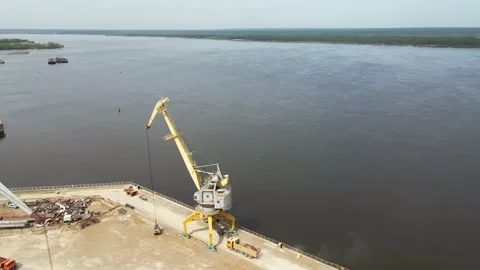 Large harbor cranes on the shore at the pier. Cargo port operation. Aerial Stock Footage 154194056