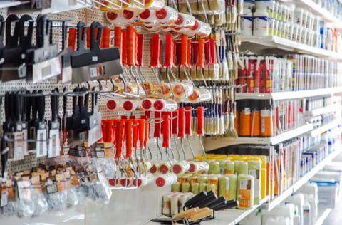 In a large hardware store there are racks with equipment for painting works B Stock Photos