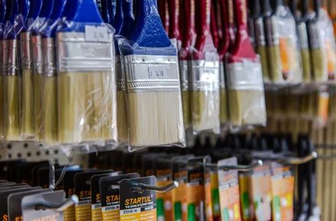 In a large hardware store there are racks with equipment for painting works B Stock Photos