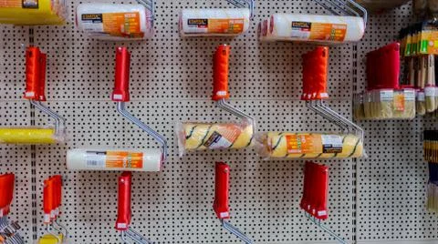 In a large hardware store there are racks with equipment for painting works B Stock Photos