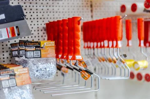In a large hardware store there are racks with equipment for painting works B Stock Photos