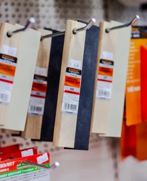 In a large hardware store there are racks with equipment for painting works B Stock Photos