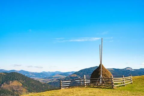 A large haystack against the backdrop of the wonderful nature of the Carpathi Stock Photos