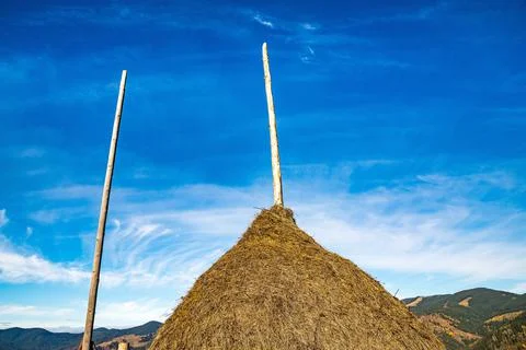 A large haystack against the backdrop of the wonderful nature of the Carpathi Stock Photos