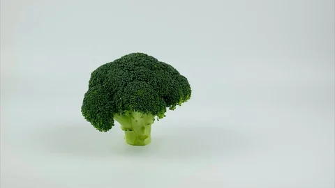 Large head of broccoli moving from left to the right. Stop motion Stock Footage 86911657
