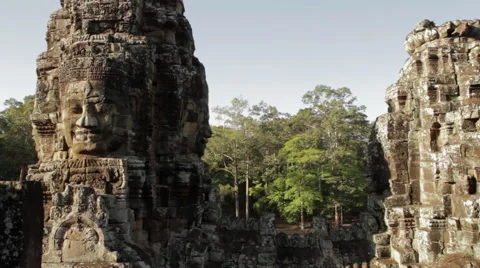 Large head carvings on pillars that form the detailed architecture of the Bayon  Stock Footage 42467743