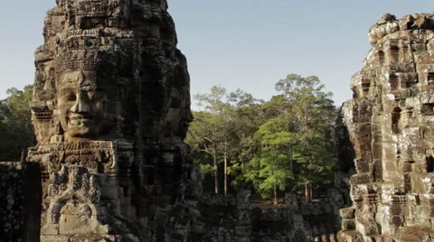 Large head carvings on pillars that form the detailed architecture of the Bayon  Stock Footage 42469819