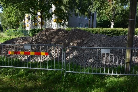 Large Heap of Crushed Stone Behind Temporary Metal Safety Fence Stock Photos