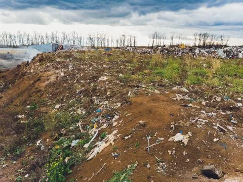 The large heap garbage dump extends parallel to the river,Garbage mountains with Stockfoto's